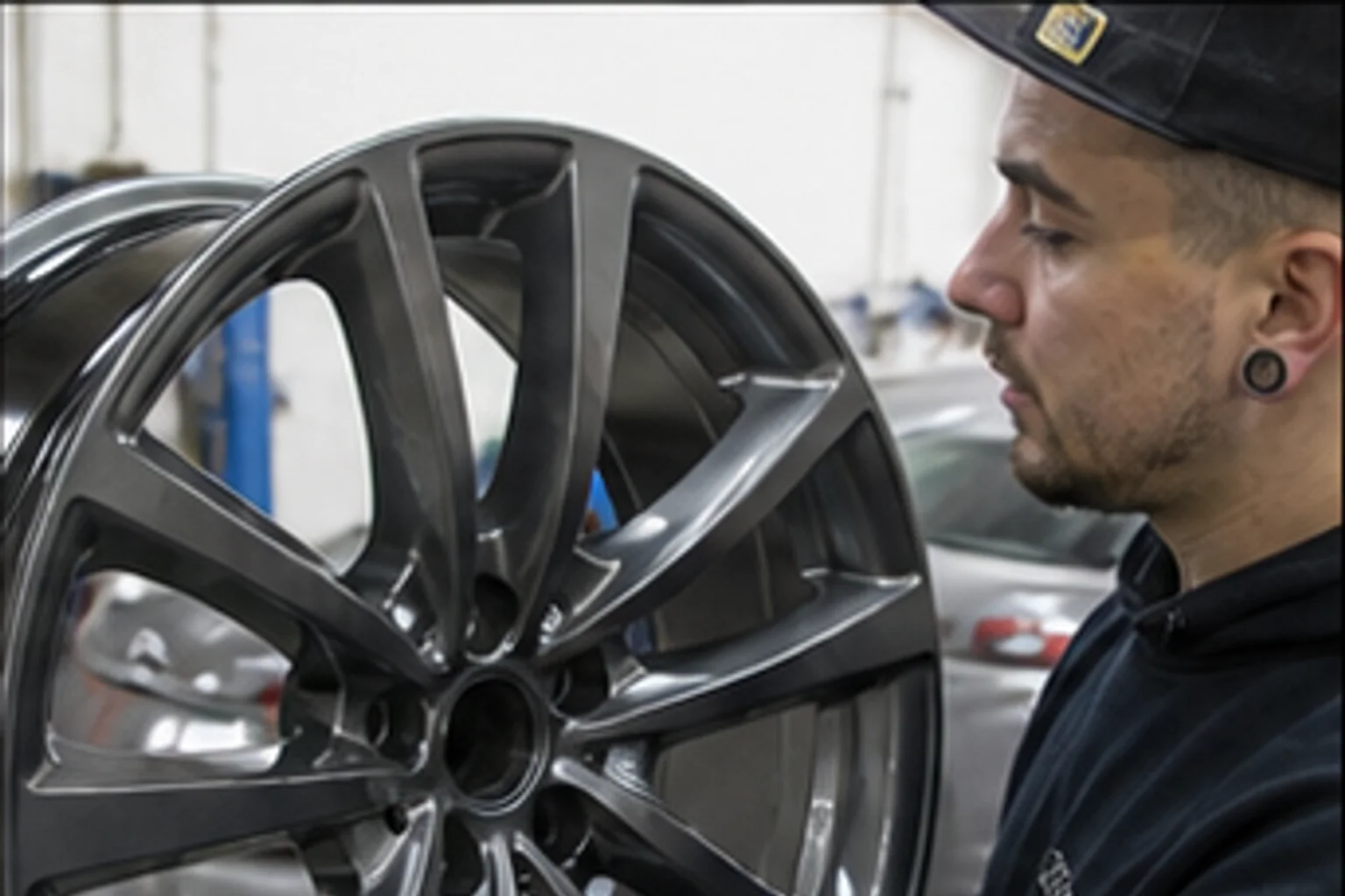 Technician inspecting repair work inside the Invisible Touch collision bay